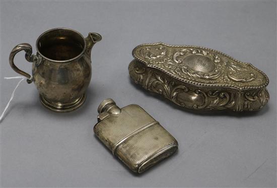 A small George V silver hip flask by Asprey & Co, a Scottish silver cream jug and a repousse silver trinket box.